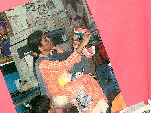  A woman gently cradles a baby in her arms, showcasing a Teeth Denture